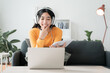 Asian girl work using laptop, online learn video conference with headphones
