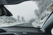 View from the car on the road in the winter forest. Auto travel holidays