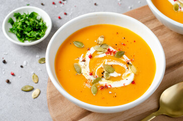 Pumpkin Soup, Tasty Homemade Pumpkin, Sweet Potato, Carrot Soup in a Bowl on Bright Background