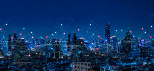 Modern city with wireless network connection and city scape concept.Wireless network and Connection technology concept with city background at night.
