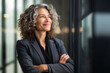 © AI_images - Happy proud prosperous mid aged mature professional business woman ceo executive wearing suit standing in office arms crossed looking away thinking of success, leadership, side profile view