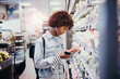 © Flamingo Images - Young woman shopping for fruit in a grocery store