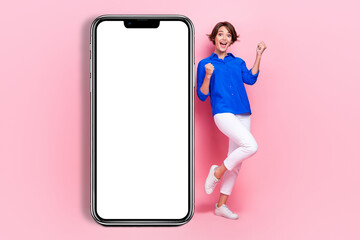 Poster - Full body size photo of young excited overjoyed woman fists up smartphone display application for business plans isolated on pink color background