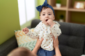 Sticker - Adorable toddler standing on sofa at home