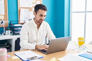 Poster - Young hispanic man business worker using laptop working at office