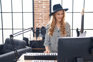 Poster - Young blonde woman musician playing piano keyboard at music studio