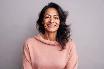 Wall Mural - Medium shot portrait of an Indian woman in her 40s in a colorful background