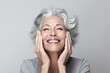 © radekcho - Beautiful gorgeous 50s mid aged mature woman looking at camera isolated on white. Mature old lady close up portrait. Healthy face skin care beauty, middle age skincare cosmetics, cosmetology concept.