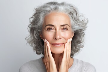 Wall Mural - Beautiful gorgeous 50s mid aged mature woman looking at camera isolated on white. Mature old lady close up portrait. Healthy face skin care beauty, middle age skincare cosmetics, cosmetology concept.