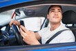 © Krakenimages.com - Young hispanic man using smartphone sitting on car at street