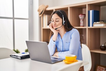 Poster - Young brunette woman wearing call center agent headset thinking looking tired and bored with depression problems with crossed arms.