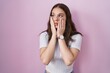 © Krakenimages.com - Young hispanic girl standing over pink background tired hands covering face, depression and sadness, upset and irritated for problem