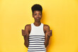 © Asier - Vibrant African woman, white tank-top, yellow studio, showing that she has no money.