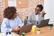 © Krakenimages.com - African american women business workers using laptop speaking at office