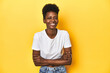 © Asier - African woman, white tee, short hair, yellow studio, laughing and having fun.