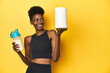 © Asier - African woman in sportswear with protein powder and shake.