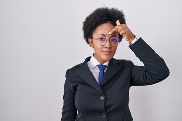 Canvas Print - Beautiful african woman with curly hair wearing business jacket and glasses pointing unhappy to pimple on forehead, ugly infection of blackhead. acne and skin problem