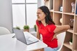 © Krakenimages.com - Young african american woman using laptop suffering for backache at home