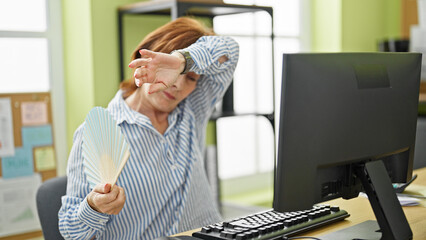 Sticker - Middle age woman business worker using handfan working at office