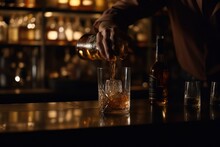 Bartender Pouring Whiskey From Bottle Into Glass At Bar Counter, Closeup