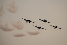 Four Airplanes In Formation On Airshow. Aerobatic Team Performs Flight At Air Show