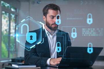 Smiling businessman in formal wear working on laptop at office workplace with smartphone and notebooks. Concept of successful business deal, agreement. Lock icons.