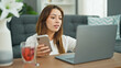 © Krakenimages.com - Young beautiful hispanic woman using laptop and smartphone sitting on floor at home