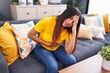 © Krakenimages.com - Young beautiful arab woman suffering for head and stomach ache at home