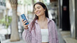 © Krakenimages.com - Young beautiful hispanic woman smiling confident using smartphone at street