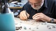 Senior jeweler working in his workshop.Jeweler making jewelry