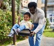 © Krakenimages.com - Father and son playing on swing at playground