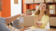 © Krakenimages.com - Man and woman ecommerce business worker giving package to client at office