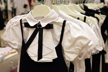 School uniform in clothing store. Different clothes for children on a rack