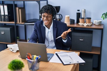 Sticker - Young african man with dreadlocks working at the office wearing headset celebrating achievement with happy smile and winner expression with raised hand