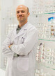 © EKKAPON - Male optician and optometrist with digital tablet on background of shop window with different models of glasses