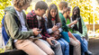 © Vittorio Gravino - Happy multicultural group of people using smartphone outdoors - Young people having fun together while watching social media