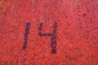 Numéro 14. Inscription peinte en noire sur mur ocre.