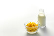 Fresh and Nutritious. Cereal and Milk Bottle in Minimalistic Glass Bowl - Captivating White Background Composition on White Background.