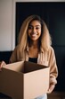 © primopiano - shot of an attractive young woman holding a box and moving into her new home
