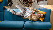 © Miljan Živković - top view man lying on sofa bed at home use mobile phone smart phone