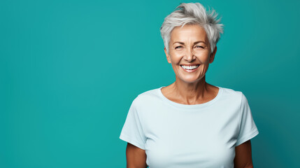 Wall Mural - Senior female standing in front of camera in white T-shirt , isolated on blue background