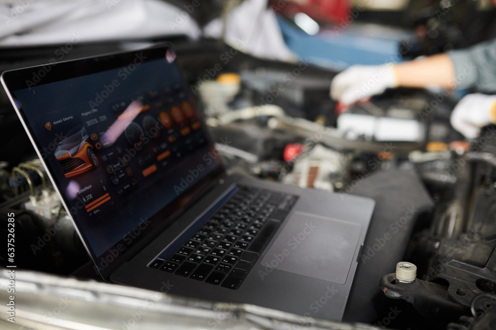 Mechanics using program on laptop when analyzing car computer systems ...