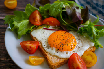 Wall Mural - Bread with fried egg, tomatoes, lettuce