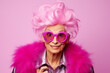 © ribalka yuli - Beautiful elderly fashionable woman in stylish pink clothes, with pink hair and glasses posing on a pink background. Woman looking at the camera in surprise