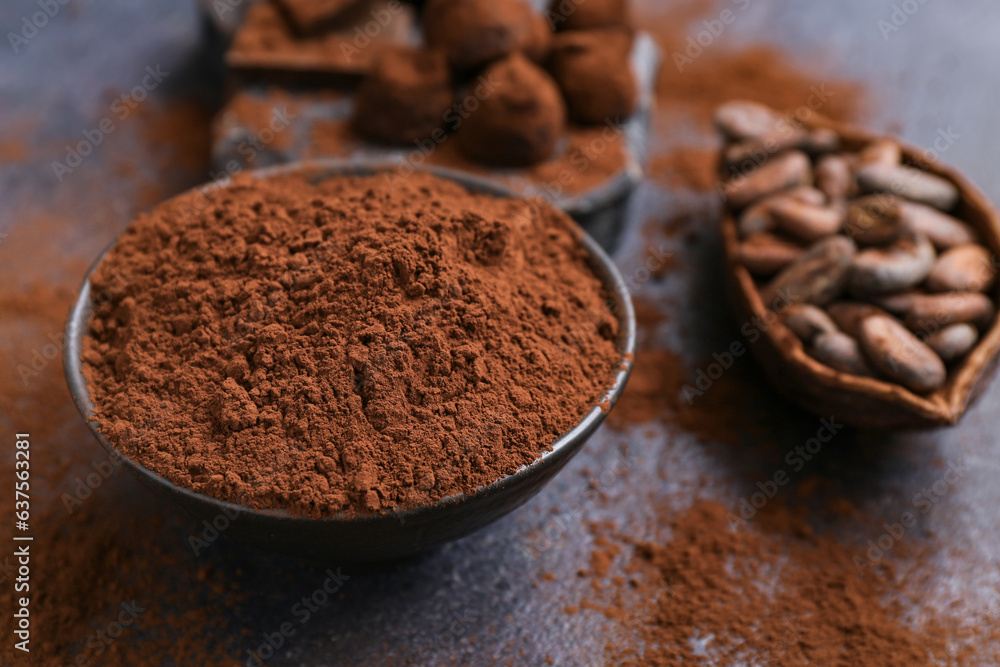 Bowl with cocoa powder on black background