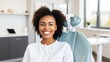 Portrait of a smiling african american woman sitting in the dentist's office. Laughing African girl with perfect teeth waiting in a doctor's cabinet. Cheerful young African girl, dental treatment