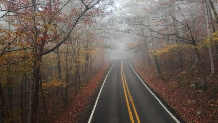 Wall Mural - Foggy and moody aerial drone over mountain road during  autumn in Ozark mountains of Arkansas 