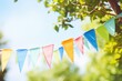 colorful pennant string decoration in green tree foliage