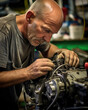 © Justlight - The Machinery Mechanic meticulously fits the components of an engine together making sure every nut and bolt is securely in place.