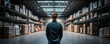 © Justlight - A Warehouse Associate stands in the center of an empty aisle hands clasped in front of them as they offer a silent prayer in thanks for their hard work in a Warehouse Associate role.